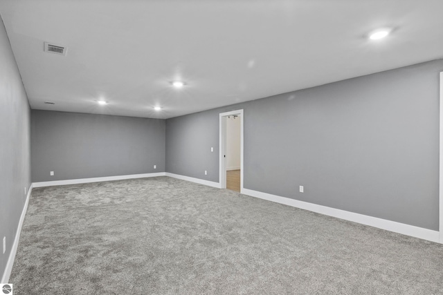 spare room with baseboards, visible vents, carpet flooring, and recessed lighting