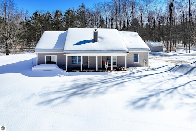 exterior space featuring a porch and a chimney