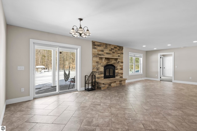 unfurnished living room with a chandelier, recessed lighting, a fireplace, and baseboards