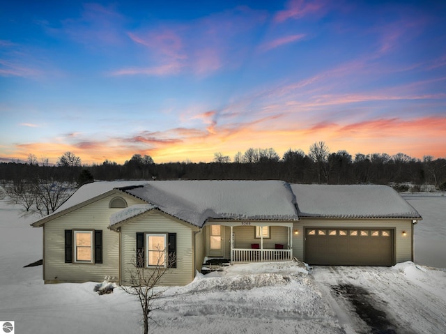 ranch-style home featuring a garage and a porch