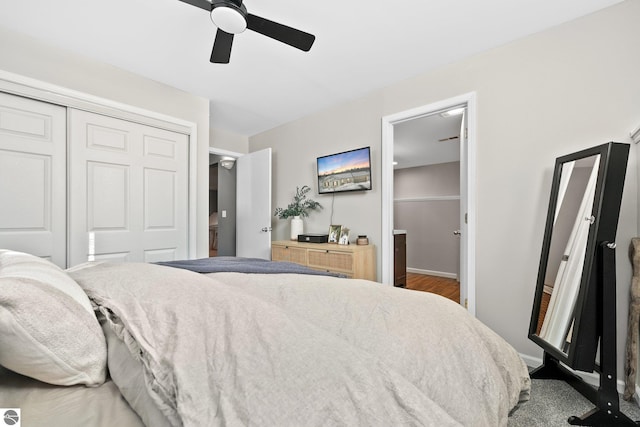 bedroom featuring baseboards, a ceiling fan, wood finished floors, ensuite bathroom, and a closet