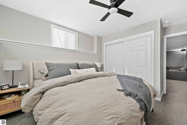 bedroom with dark colored carpet, a closet, and ceiling fan