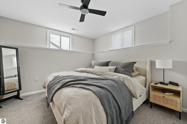 bedroom featuring ceiling fan, visible vents, dark carpet, and baseboards