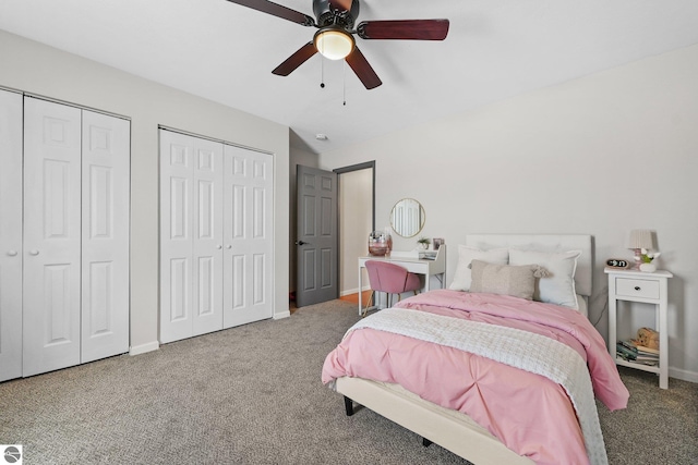 bedroom with a ceiling fan, carpet flooring, baseboards, and two closets