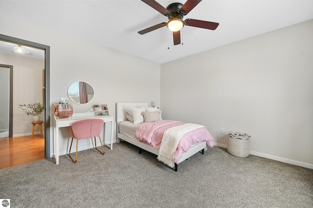 carpeted bedroom with a ceiling fan and baseboards