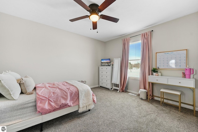 carpeted bedroom with ceiling fan and baseboards