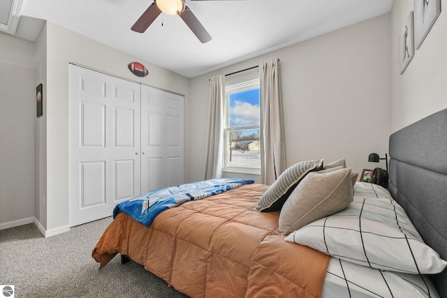 bedroom featuring ceiling fan, a closet, carpet flooring, and baseboards