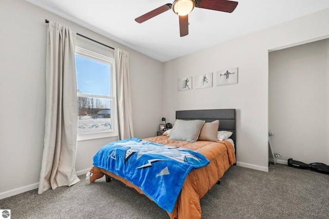 bedroom featuring baseboards, dark colored carpet, and a ceiling fan