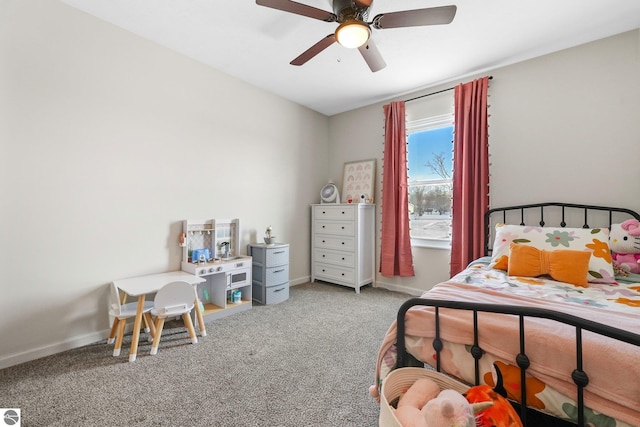 bedroom featuring a ceiling fan, light colored carpet, and baseboards