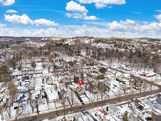 snowy aerial view with a residential view