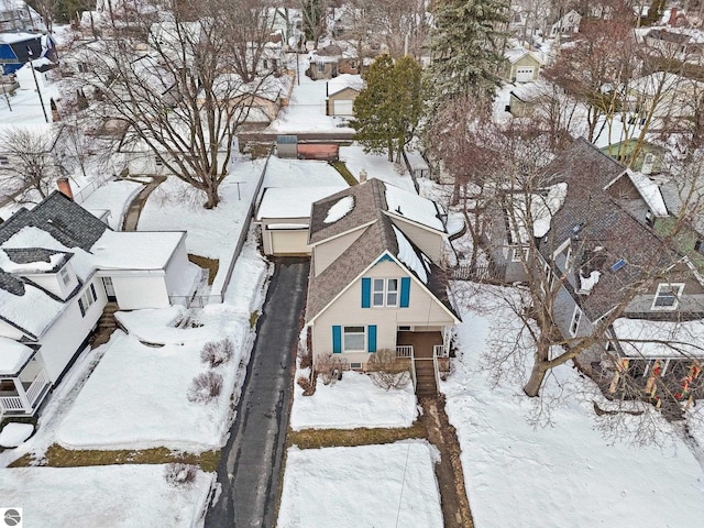 snowy aerial view with a residential view