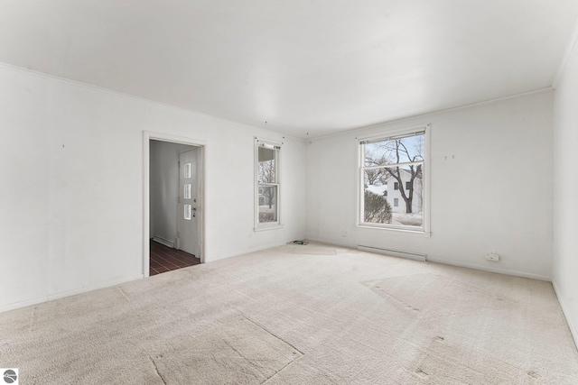 carpeted empty room with a baseboard heating unit