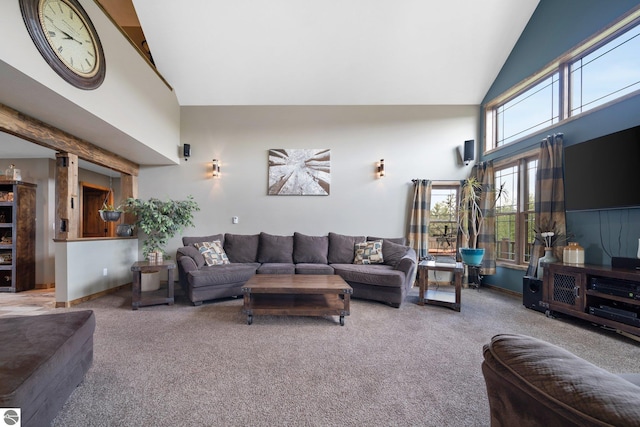 carpeted living area with high vaulted ceiling