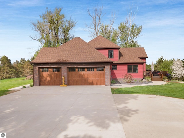 view of front of property featuring a garage, a shingled roof, driveway, a wooden deck, and a front lawn