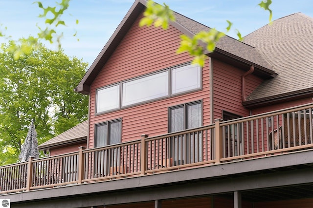 view of property exterior featuring a shingled roof