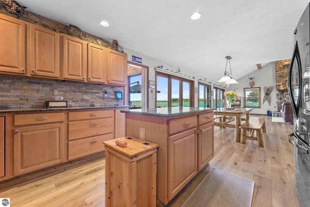 kitchen featuring plenty of natural light, pendant lighting, a kitchen island, and lofted ceiling