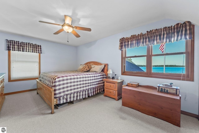 bedroom with light carpet, ceiling fan, and baseboards