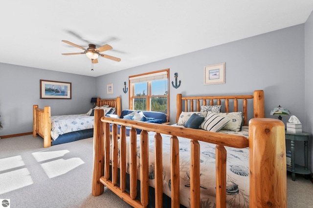 carpeted bedroom with baseboards and a ceiling fan