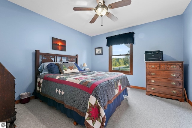 bedroom with ceiling fan, baseboards, and light colored carpet