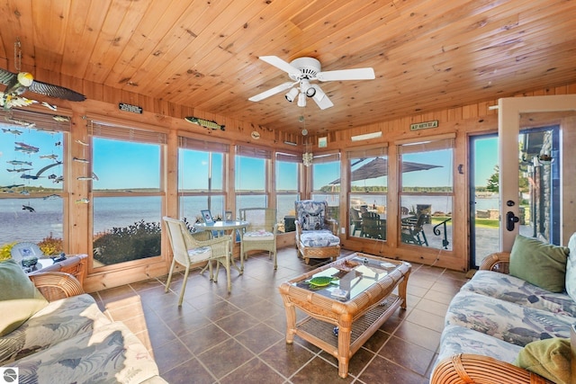 living room with wooden ceiling, a water view, a wealth of natural light, and tile patterned floors