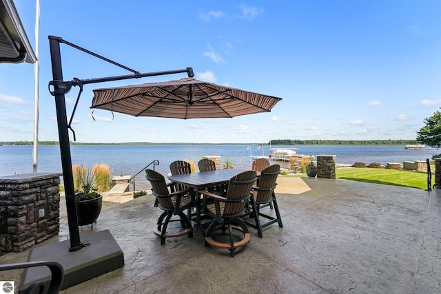 view of patio with outdoor dining space and a water view