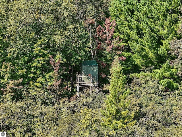 birds eye view of property with a view of trees