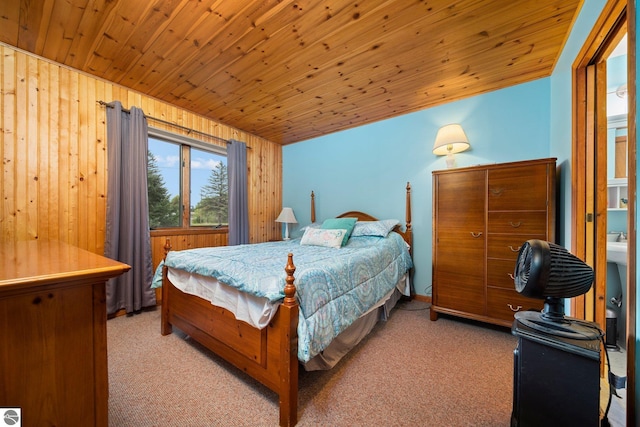 bedroom with light carpet, wood walls, and wooden ceiling