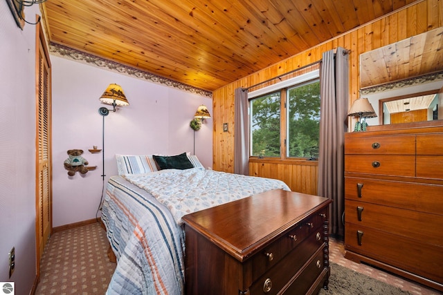 bedroom featuring wooden ceiling, light colored carpet, and baseboards