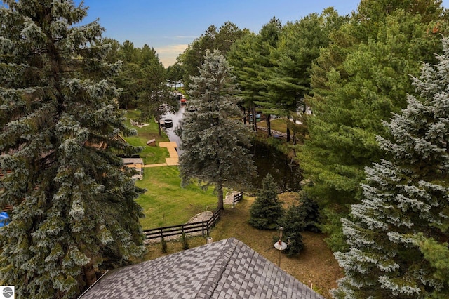 view of community with a yard and fence