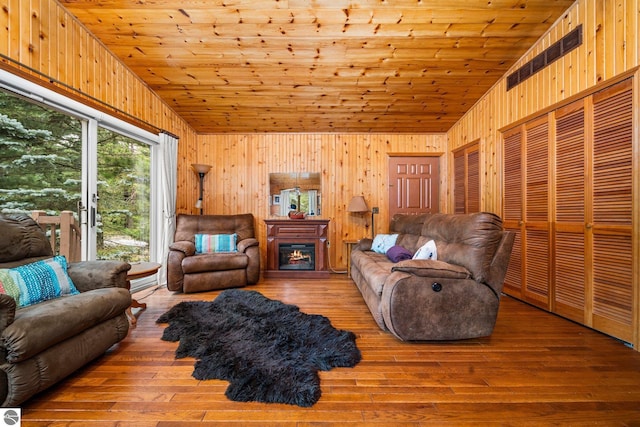 living room featuring lofted ceiling and hardwood / wood-style flooring