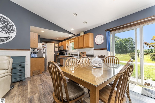 dining area featuring plenty of natural light, vaulted ceiling, recessed lighting, and wood finished floors