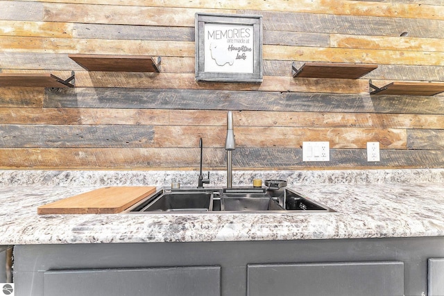 kitchen with wood walls and a sink