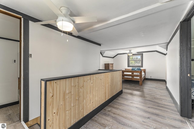 bar featuring ceiling fan, lofted ceiling with beams, wood finished floors, and baseboards