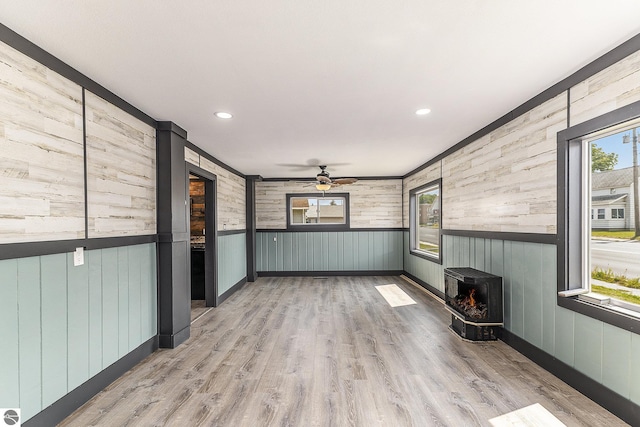 interior space featuring a wood stove and ceiling fan