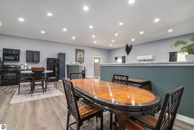 dining area featuring baseboards, light wood-style flooring, and recessed lighting
