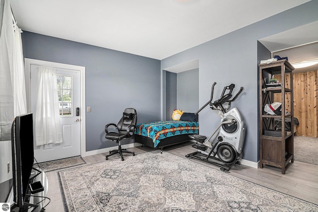 bedroom with baseboards and wood finished floors