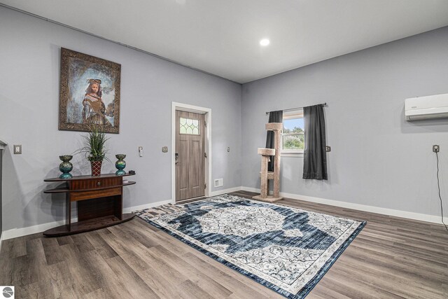 entryway featuring recessed lighting, baseboards, wood finished floors, and a wall mounted AC