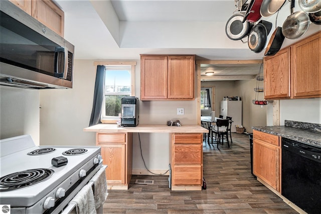 kitchen with dark wood-style flooring, white range with electric cooktop, stainless steel microwave, visible vents, and dishwasher