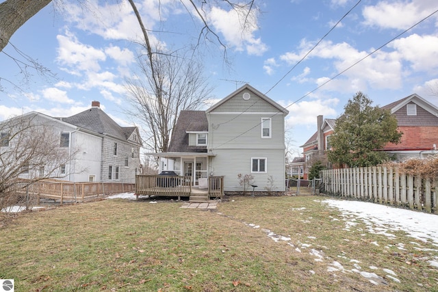 back of house featuring a deck, a lawn, and fence