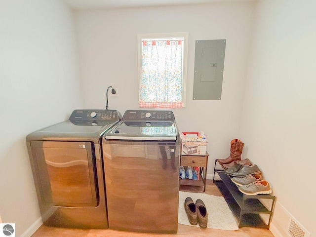 laundry area featuring laundry area, visible vents, baseboards, independent washer and dryer, and electric panel