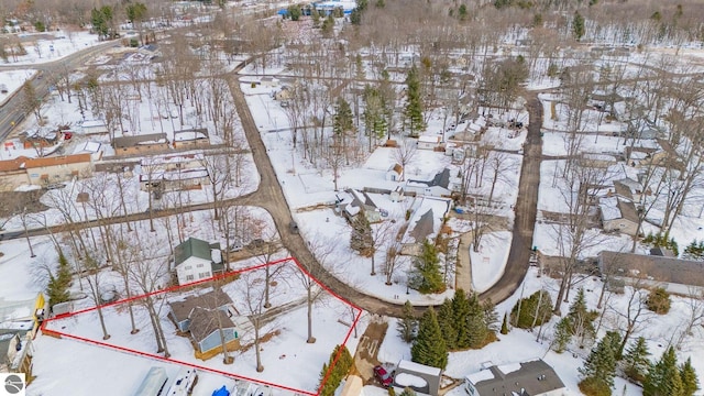 snowy aerial view with a residential view