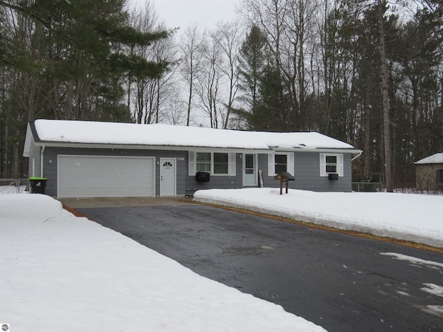 single story home featuring driveway and an attached garage