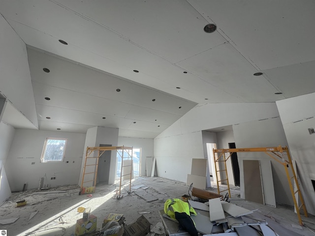 unfurnished room featuring vaulted ceiling