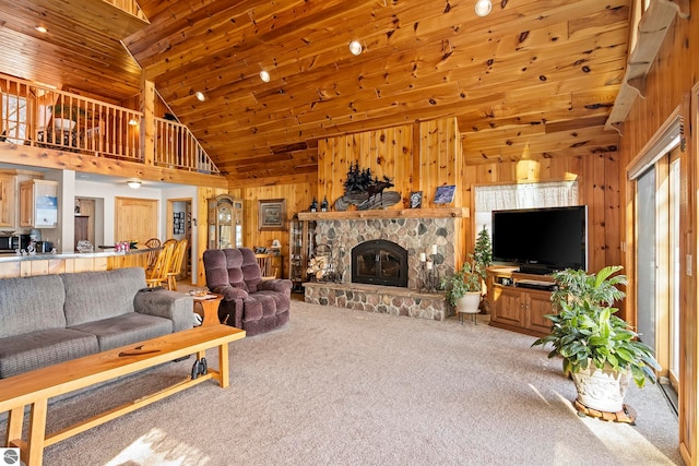 carpeted living area with high vaulted ceiling, wooden ceiling, a fireplace, and wooden walls