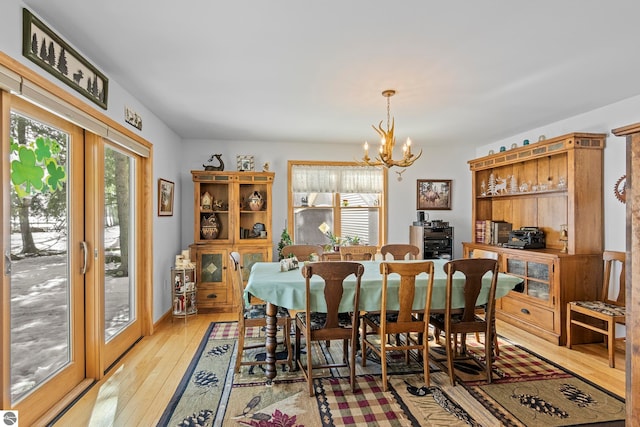 dining room featuring light wood-style floors and an inviting chandelier