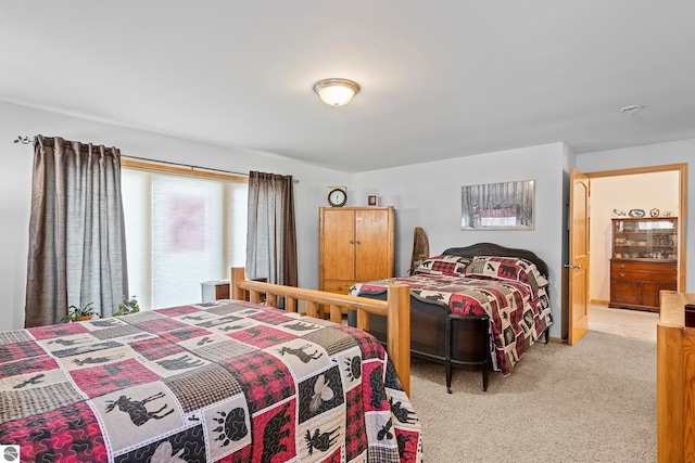 bedroom featuring light carpet and baseboards