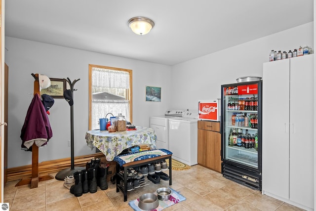 interior space with light tile patterned floors and separate washer and dryer