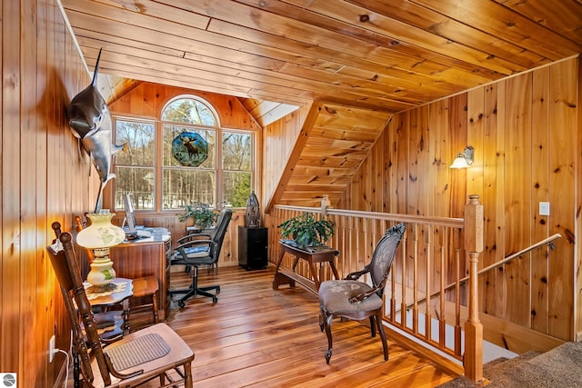 home office with lofted ceiling, wooden ceiling, wood walls, and hardwood / wood-style flooring