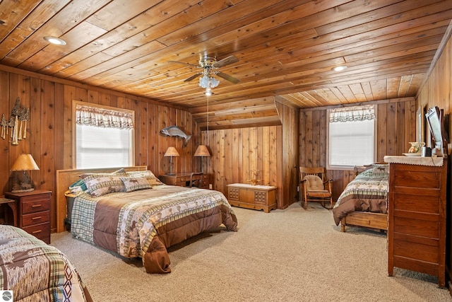 bedroom with wooden ceiling, wooden walls, and carpet flooring