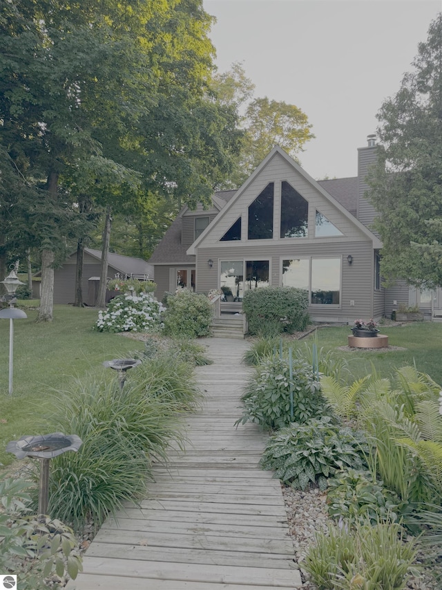 back of property featuring a lawn and a chimney